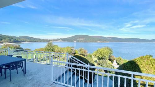 a balcony with a view of a body of water at The Cliffs - ArealongaBeach in O Vicedo