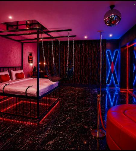 a room with a bed with a swing in it at Love Room- Adult Only in Bucharest