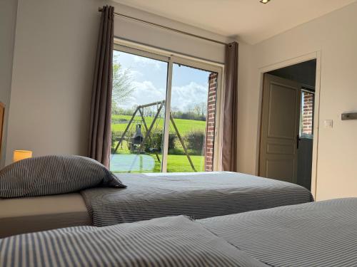 a bedroom with a bed and a large window at Gite Ô pré in Beaubec-la-Rosière