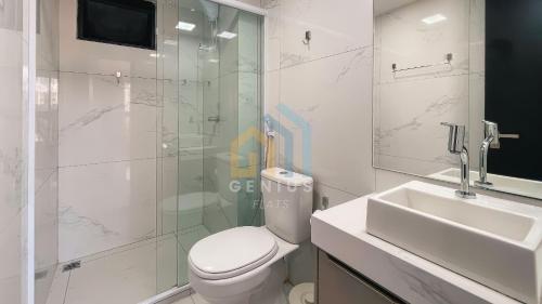 a bathroom with a toilet and a sink and a shower at Move Tambaú Genius Flats in João Pessoa