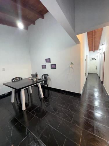 a room with a table and chairs in a room at Esquina Hostel in Esquina