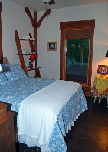 a bedroom with a bed and a window at Timber Ridge in Franklin