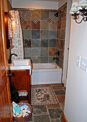 a bathroom with a tub and a sink at Timber Ridge in Franklin