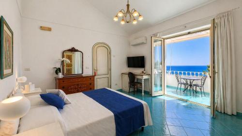 a bedroom with a bed and a view of the ocean at Casa Guadagno in Positano