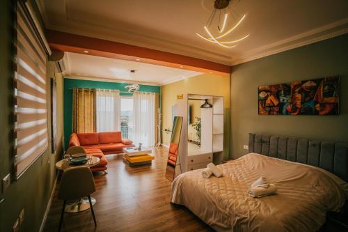 a bedroom with a bed and a living room at Tirana SkyView in Tirana