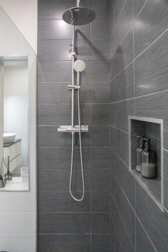 a shower with a shower head in a bathroom at Sun & Salt Villa in Alvor