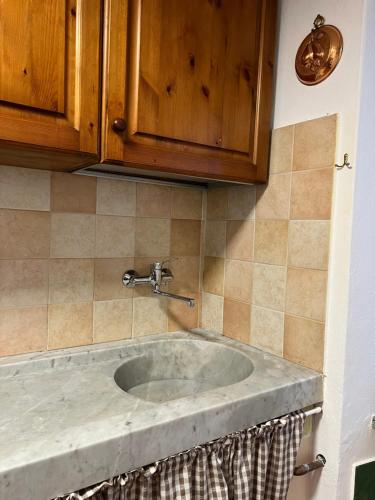 a sink in a kitchen with a counter top at Casa San Rocco in Busalla
