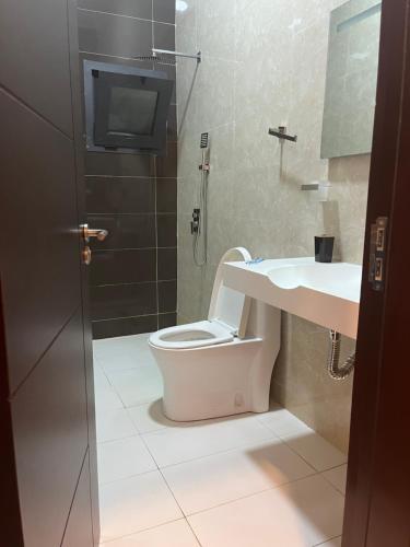 a bathroom with a toilet and a sink at Villa Abou in Assinie