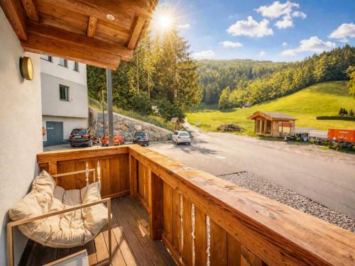a wooden balcony with a view of a road at OLDWOOD CHALET - Design Chalet & Balcony in Fügen