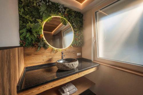 a bathroom with a sink and a mirror at OLDWOOD CHALET - Design Chalet & Balcony in Fügen