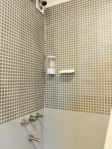 a bathroom with a tiled shower with a sink at Melincue Arenas in Melincué