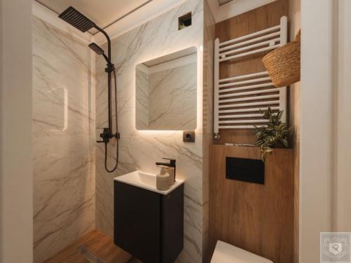 a bathroom with a toilet and a sink and a mirror at RentHouse Apartments Panoramic-Airport-Studio in Chişinău