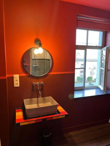 a bathroom with a sink and a mirror at L' Ecole in Durbuy