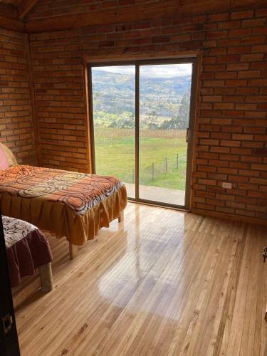 a room with a bed and a large window at Pakarina WASY in San Miguel