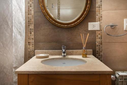 a bathroom with a sink and a mirror at Balcones al Nahuel II in San Carlos de Bariloche