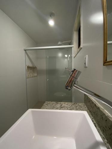 a bathroom with a sink and a shower at Pousada Ypê Amarelo in Itatiaia