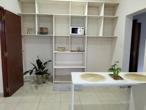 a room with white shelves and a white table at Suite Premium Perico Jujuy con Parking in Establecimiento La Candelaria