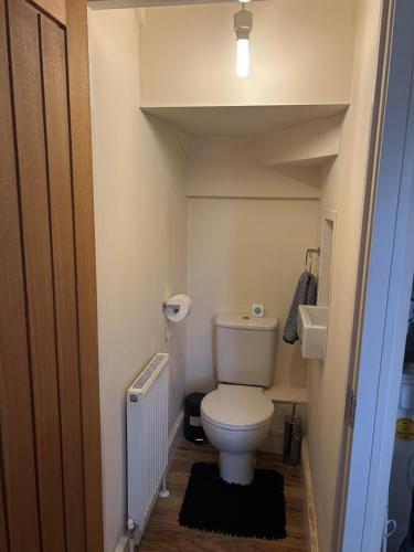 a small bathroom with a toilet and a sink at Comfort Horizon Egham in Egham
