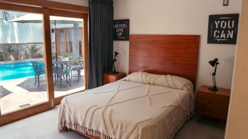 a bedroom with a bed and a swimming pool at Quinta San Ignacio in Guadalajara