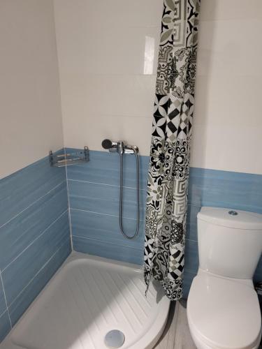 a bathroom with a tub and a toilet and a shower at Castle View #3-4 in Kavála