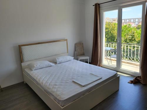 a bedroom with a bed and a large window at Castle View #3-4 in Kavála