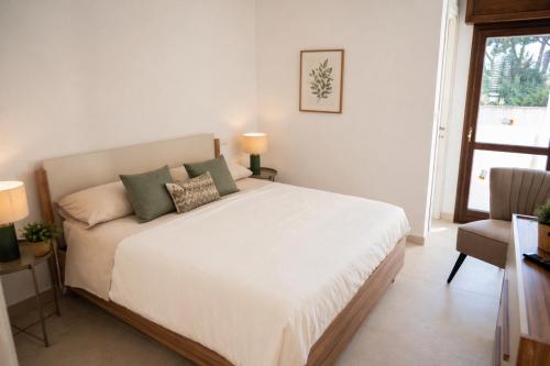 a bedroom with a large white bed and a window at Casa Maria in Oria