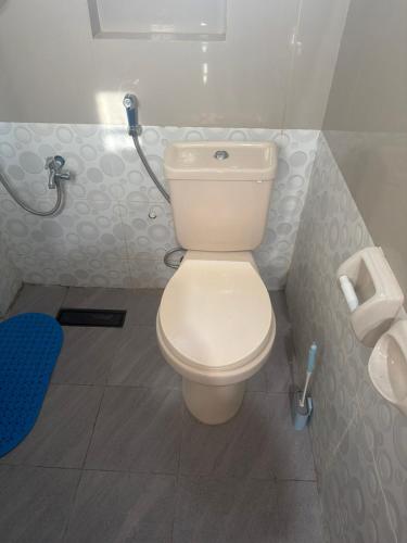a bathroom with a white toilet in a stall at stayhouse in Gapan