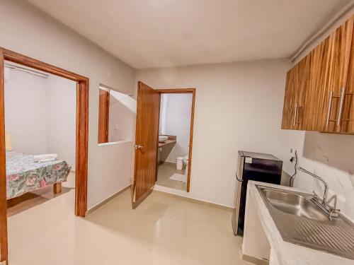 a kitchen with a sink and a door to a bathroom at Amaizing view Islas Marietas in Punta Mita