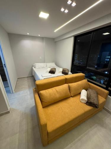 a living room with a couch and a bed at Carneiros Pernambuco in Tamandaré