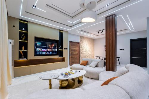 a living room with a couch and a table at Modern Luxury 2BR Spacious Cozy 24hr Power in Lekki