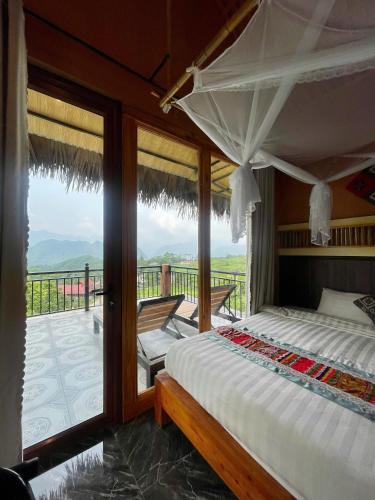 a bedroom with a bed and a balcony with a view at Pù Luông Happy Home in Lũng Tiềm