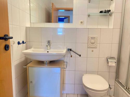 a small bathroom with a sink and a toilet at Ferienwohnung in Orth auf Fehmarn in Orth