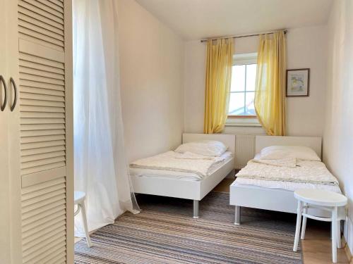 a bedroom with two beds and a window at Ferienwohnung in Orth auf Fehmarn in Orth