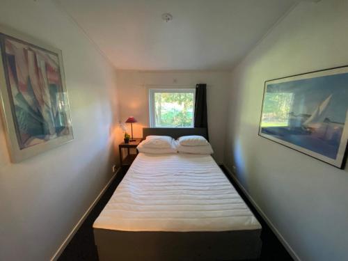 two beds in a small room with a window at 6 person holiday home in Ucklum-By Traum in Ucklum