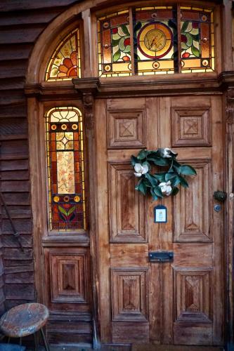 a wooden door with stained glass windows on a house at CIRQUE 5 - Alpine Lodge built around a ski lift tower in Merrijig