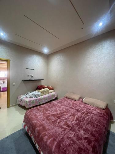 a bedroom with two beds in a room at Route Agafay in Aït Ali