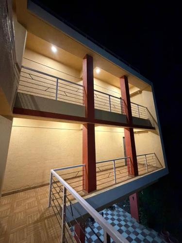 a view of a building with a balcony at night at Horizon cottage in Nagaon