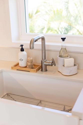 a kitchen counter with a sink and a window at Cottage Three - Hidden Gem on Hanalei River in Hanalei