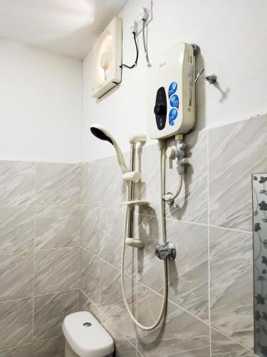 a shower in a bathroom with a toilet at D'Aleena Inn Kodiang in Kodiang