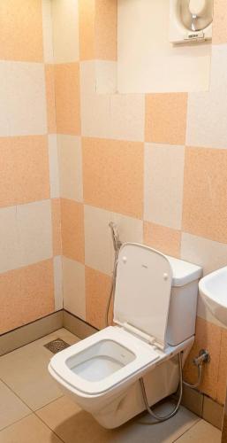 a bathroom with a toilet with the lid up at ROYAL INN in Trivandrum