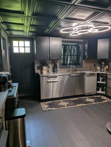 a kitchen with stainless steel appliances and a door at The Raven in Madison