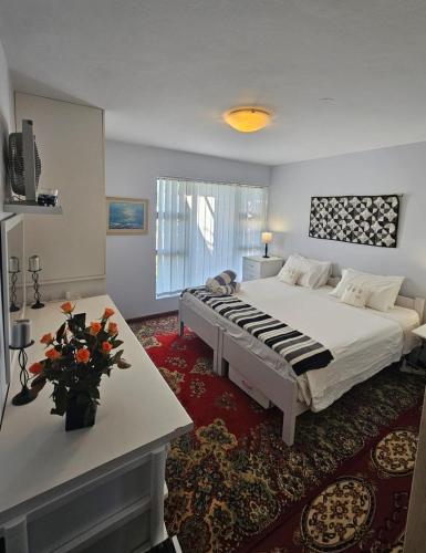 a large bedroom with a large bed and a table at Marine View in Plettenberg Bay