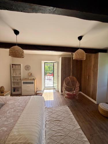 a bedroom with a bed and a door to a yard at La Grange de Bosc -Ardèche verte - Proche train de Lamastre in Saint-Prix