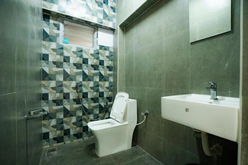a bathroom with a toilet and a sink at Classic Horizon in Mahabalipuram