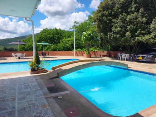 a large swimming pool with blue water at Hotel OK El Edén in Tocaima