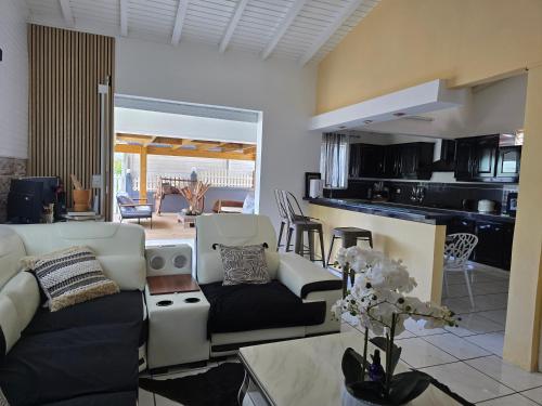 a living room with a couch and a table at Villa Chelsy in Capesterre-Belle-Eau