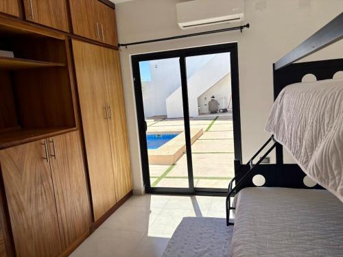 a bedroom with a bed and a sliding glass door at Casa Flamingo, San Carlos in San Carlos