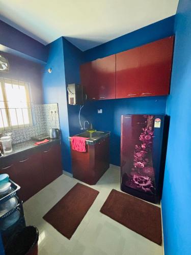 a kitchen with a fishtank in the corner of a room at Serene Cove Homestay in Dispur