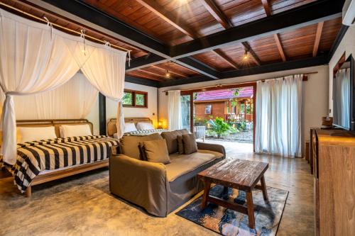 a living room with a couch and a bed at Hidden Paradise West Sumbawa Yo Yos in Sekongkang Bawa