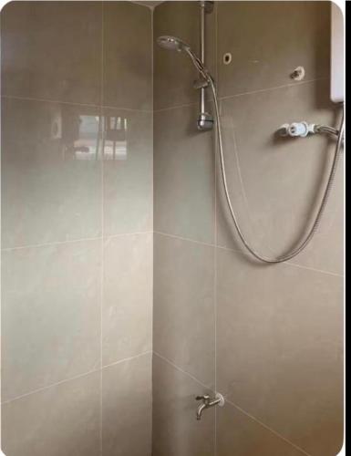 a shower with a glass door in a bathroom at Studio Apartment in Mactan, Cebu Room304 in Lapu Lapu City